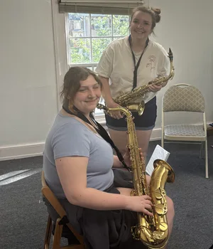 Two saxophone students with alto and tenor saxophones at Downingtown Music Academy