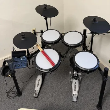 An electronic drum kit with mesh pads, headphones and drumsticks at Downingtown Music Academy