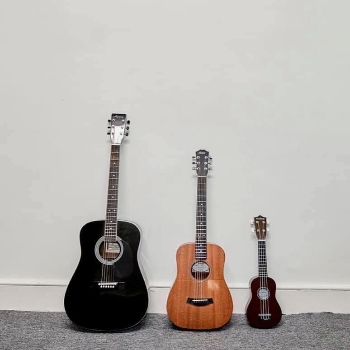 Image of guitars and ukulele leaning against the wall