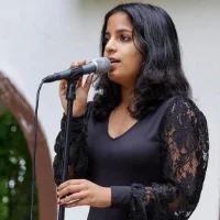 A girl singing at her voice recital