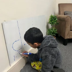 Image of a child drawing a music note