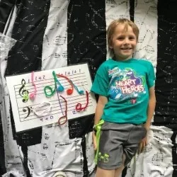 Image of a child with their musical composition