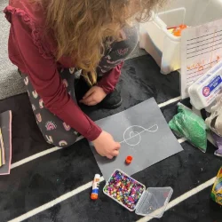 Image of a child drawing a treble clef