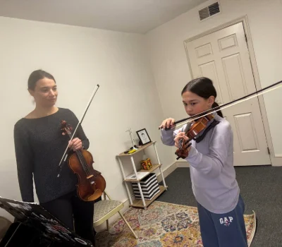 A student violinist in her lesson with violin teacher Rachel