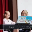 child performing in music recital